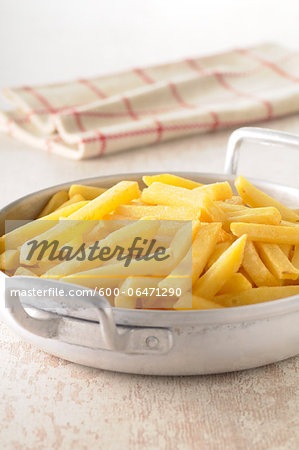 Close-up of French Fries in Pan with Tea Towel in Background