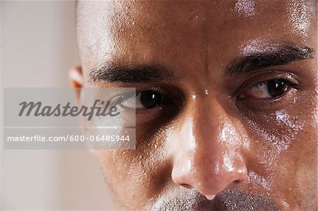 Close-Up Man's Sweating Face in Studio with White Background