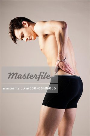 Close-up of Young Man in Underwear Touching Stomach in Studio - Stock Photo  - Masterfile - Premium Royalty-Free, Artist: Uwe Umstätter, Code:  600-06486010