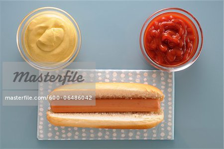 Overhead View of Hot Dog with Bowls of Ketchup and Mayonnaise, Studio Shot