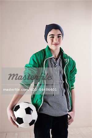 Portrait of Boy with Soccer Ball in Studio