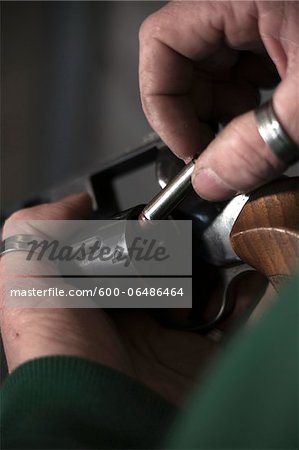 Close-up of Man Loading Bullets into Gun, Mannheim, Baden-Wurttemberg, Germany