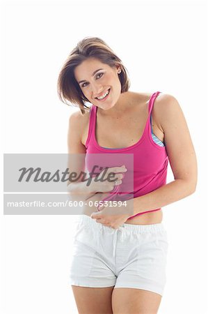 Portrait of Young Woman wearing Tank Top and Shorts in Studio