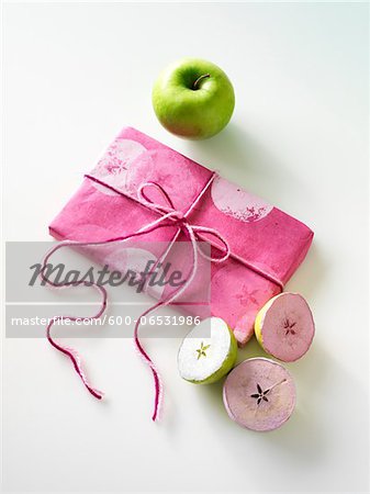 Gift, Craft demonstration of how to use granny smith apples cut in half and dipped in pink and white paint to make wrapping paper