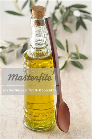 Bottle of Olive Oil with Wooden Spoon