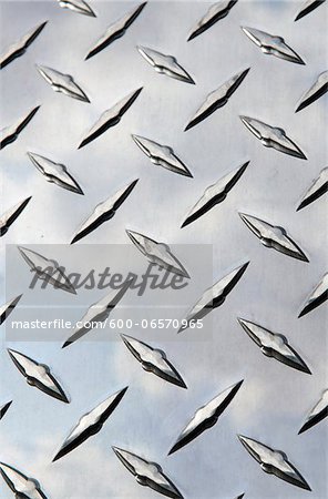 Stainless steel diamond plate facade with reflection of clouds Stainless steel diamond plate facade with reflection of clouds