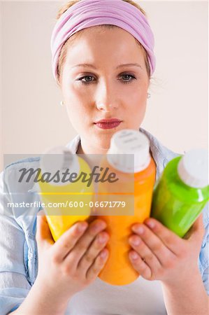 Studio Shot of Young Woman Holding Containers of Paint