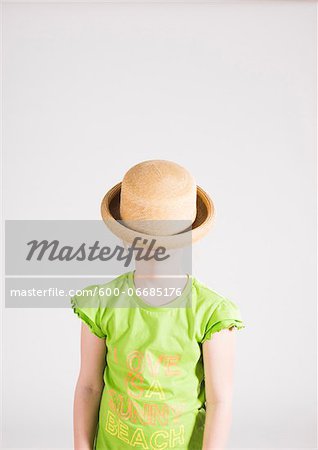 Portrait of Girl with Hat Covering her Face in Studio