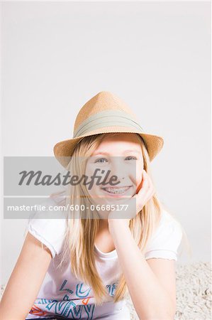 Portrait of Girl with Braces wearing Hat in Studio