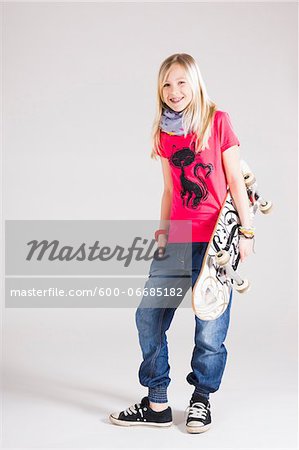 Full Length Portrait of Girl with Skateboard in Studio