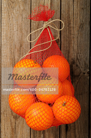 Bag of Oranges Hanging on Wall, Studio Shot