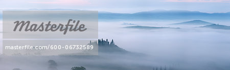 Typical Tuscany landscape in morning with fog, in foreground is Podere Belvedere a farm near San Quirico d'Orcia. Val d'Orcia, Orcia Valley, Siena district, Tuscany, Toscana, Italy.