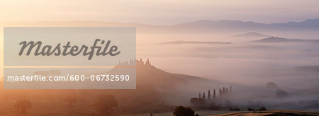 Typical Tuscany landscape in morning with fog, in foreground is Podere Belvedere a farm near San Quirico d'Orcia. Val d'Orcia, Orcia Valley, Siena district, Tuscany, Toscana, Italy.