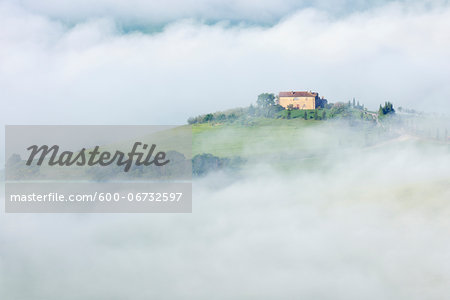 Typical Tuscany landscape with farm in morning with fog near Pienza. Pienza, Siena district, Tuscany, Toscana, Italy.