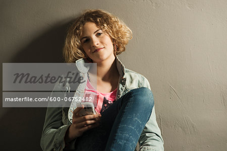 Teenage Girl using Cell Phone, Studio Shot