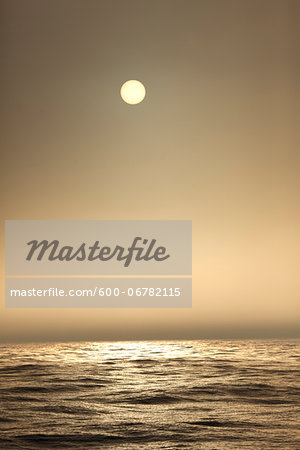 The Atlantic ocean illuminated by sun as seen from a sailboat at sea in the fog The Atlantic ocean illuminated by sun as seen from a sailboat at sea in the fog