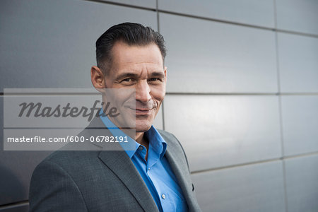 Portrait of businessman standing in front of building, Mannheim, Germany