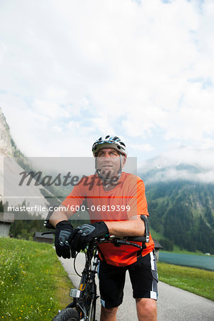 Mature Man Mountain Biking at Vilsalpsee, Tannheim Valley, Tyrol, Austria