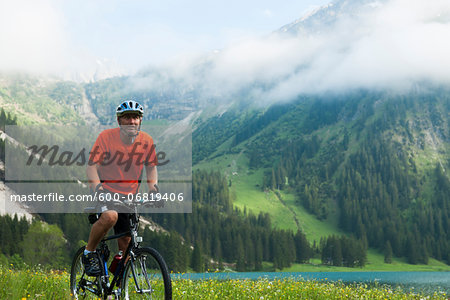 Mature Man Riding Mountain Bike by Vilsalpsee, Tannheim Valley, Tyrol, Austria