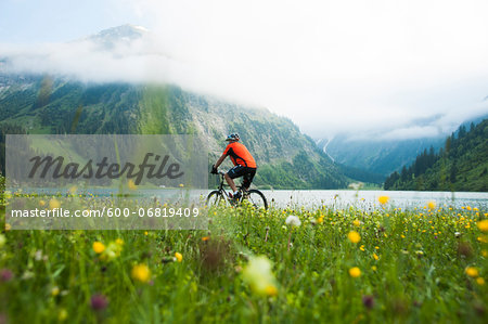 Mature Man Riding Mountain Bike by Vilsalpsee, Tannheim Valley, Tyrol, Austria