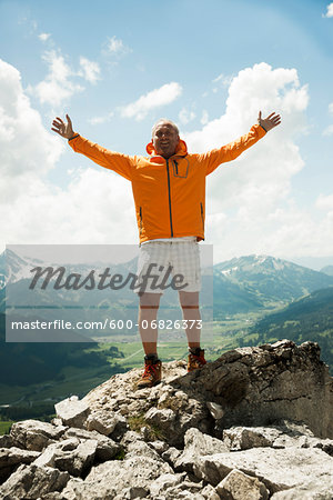 Mature man with arms raised in air, hiking in mountains, Tannheim Valley, Austria Mature man with arms raised in air, hiking in mountains, Tannheim Valley, Austria