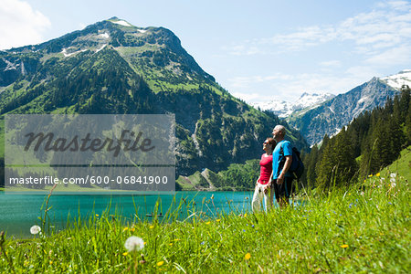 Mature man and woman looking at scenic view, Lake Vilsalpsee, Tannheim Valley, Austria