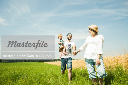 Family Walking by Agricultural Field, Mannheim, Baden-Wurttemberg, Germany Family Walking by Agricultural Field, Mannheim, Baden-Wurttemberg, Germany