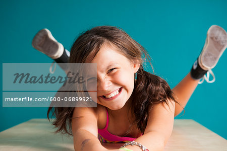 Portrait of girl looking at camera, making funny faces, Germany