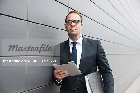 Portrait of Businessman using Tablet Computer Outdoors, Mannheim, Baden-Wurttemberg, Germany