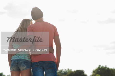 Backview of teenage boy and teenage girl with arms around each other,  standing outdoors, Germany - Stock Photo - Masterfile - Premium  Royalty-Free, Artist: Uwe Umstätter, Code: 600-06961039