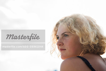 Close-up portrait of teenage girl outdoors, looking into the distance, Germany