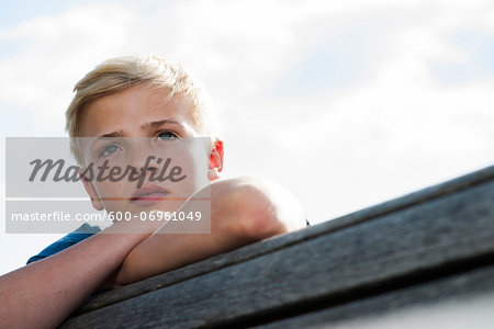 Close-up portrait of boy outdoors, looking into the distance, Germany