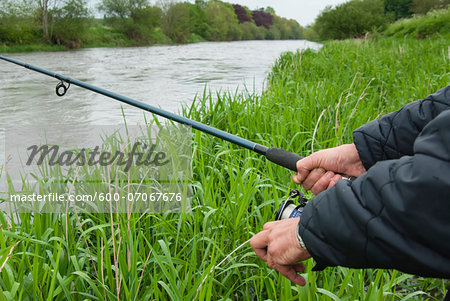 Close-up of man fishing at Mount Juliet Estate, River Nore, Thomastown, County Kilkenny, Leinster, Republic of Ireland
