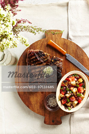 Overhead View of Steak and Salad on Cutting Board, Studio Shot Overhead View of Steak and Salad on Cutting Board, Studio Shot