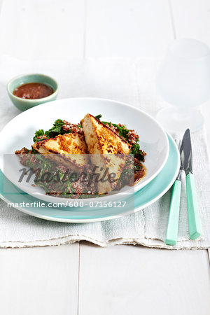 Honey ginger tofu on quinoa and kale salad, studio shot Honey ginger tofu on quinoa and kale salad, studio shot