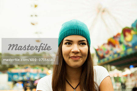 Close-up portrait of teenage girl smiling at amusement park, Germany Close-up portrait of teenage girl smiling at amusement park, Germany