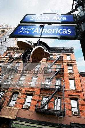 View of old brownstones and street signs, New York City, New York, USA View of old brownstones and street signs, New York City, New York, USA