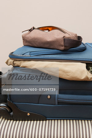 travel bag on top of suitcase