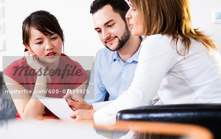 Businesswoman in discussion with young couple, Germany