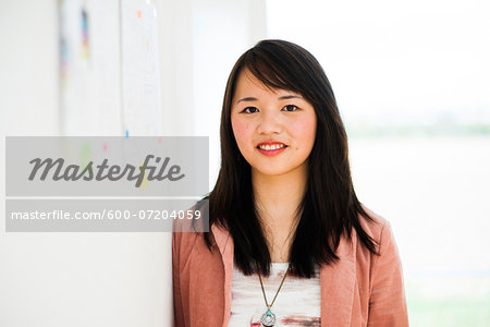 Portrait of Young Businesswoman in Office, Mannheim, Baden-Wurttemberg, Germany