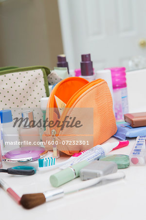 Women's Toiletry Travel Bag on Bathroom Counter filled with Personal Hygiene Products