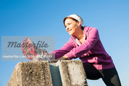 Mature Woman Stretching Outdoors, Mannheim, Baden-Wurttemberg, Germany