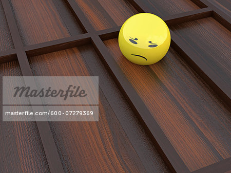 3D Illustration of Yellow Glass Marble with Sad Face