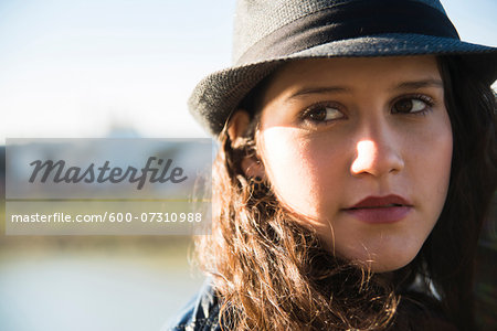 Close-up portrait of teenage girl wearing fedora, Germany