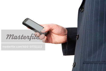 Close-up of businessman's hand holding smart phone, studio shot on white background