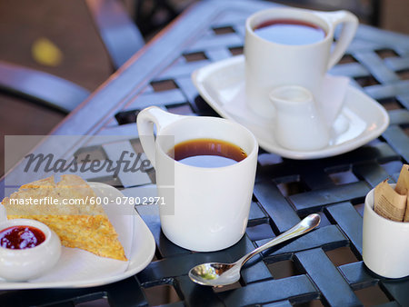 Two White Mugs of Tea on Patio Table with Scone and Jam, Dundas, Ontario, Canada