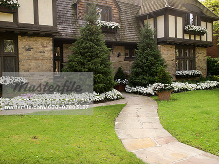 View of house exterior and front walkway and garden in summer, Toronto, Ontario, Canada View of house exterior and front walkway and garden in summer, Toronto, Ontario, Canada