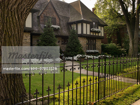 View of iron fence and house exterior in summer, Toronto, Ontario, Canada View of iron fence and house exterior in summer, Toronto, Ontario, Canada