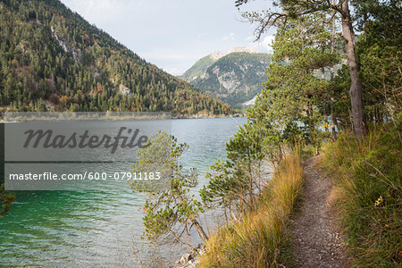 Landscape of a trail beside a clear lake in autumn, Plansee, Tirol, Austria