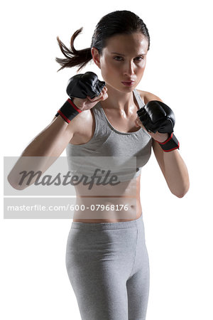 Portrait of Young Woman wearing Boxing Gloves, Studio Shot